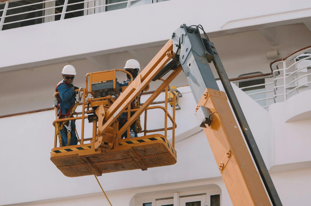 Workers on a scissor lift.